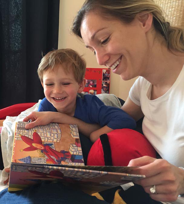 Mom and Kids Laugh While Reading Books